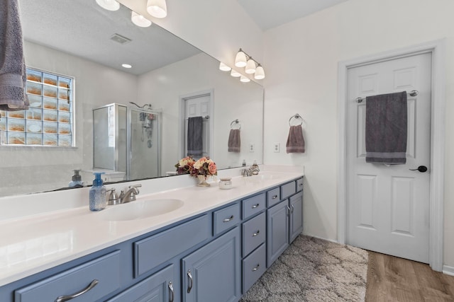 6242 Fieldstone Cir, Charleston, SC 29414 - bathroom with a stall shower, double vanity, and wood finished floors