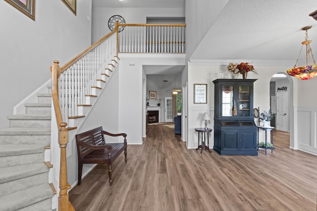6242 Fieldstone Cir, Charleston, SC 29414 - entryway featuring stairway, wood finished floors, a ceiling fan, arched walkways, and a high ceiling