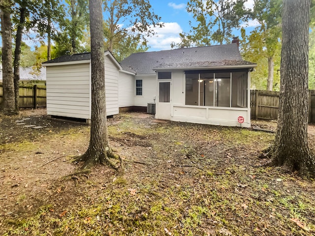 back of property featuring central AC unit and a sunroom