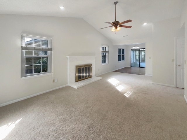 unfurnished living room featuring carpet flooring, ceiling fan, high vaulted ceiling, and a fireplace