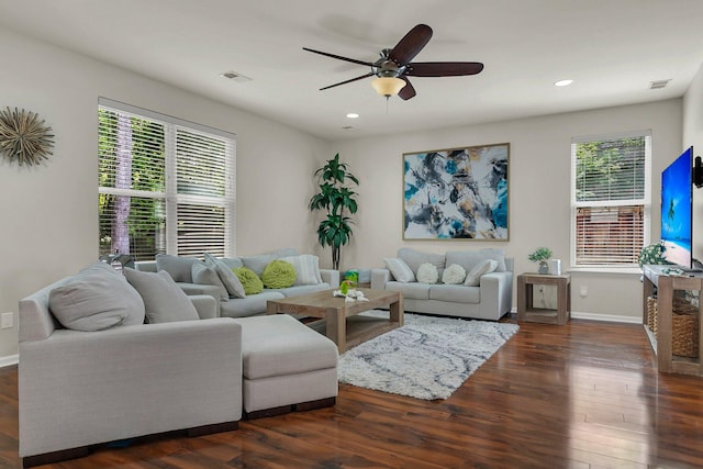 living room featuring dark hardwood / wood-style flooring and ceiling fan