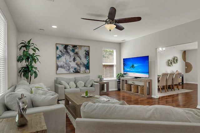 living room with ceiling fan and dark hardwood / wood-style floors