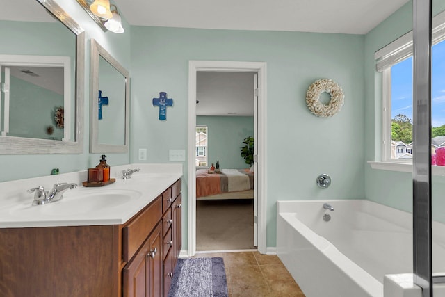 bathroom with a bath, tile patterned floors, and vanity