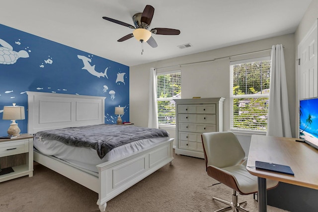 bedroom with multiple windows, carpet floors, and ceiling fan