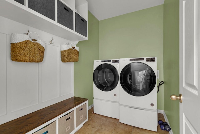 clothes washing area featuring washing machine and dryer and light tile patterned floors