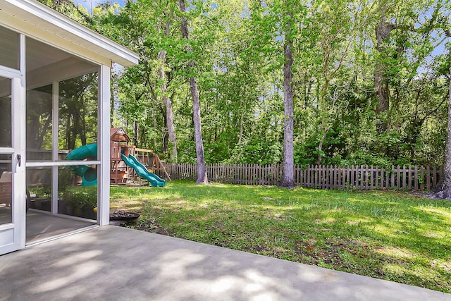 view of yard featuring a playground and a patio