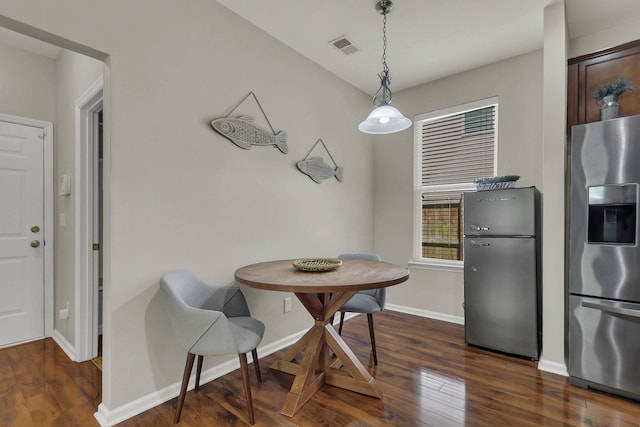 dining area with dark hardwood / wood-style flooring