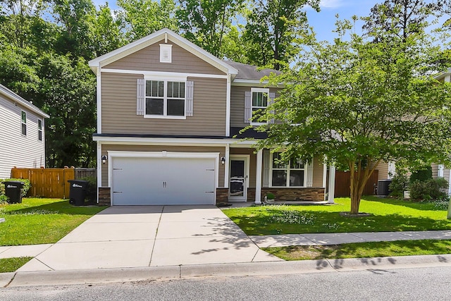 view of front facade featuring a garage, a front lawn, and central AC unit