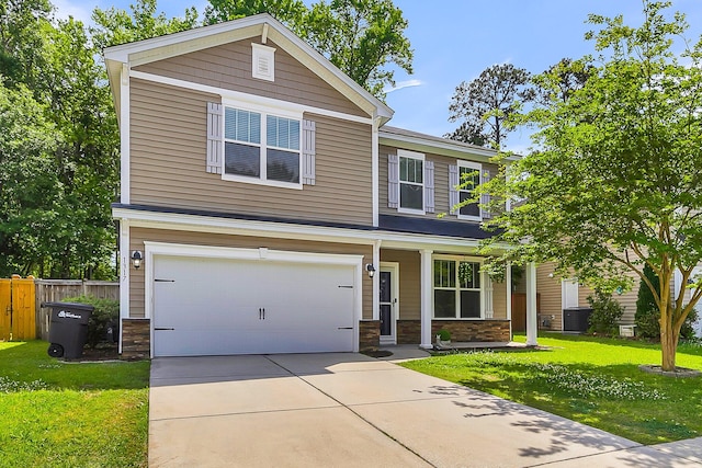 craftsman inspired home with a garage and a front lawn