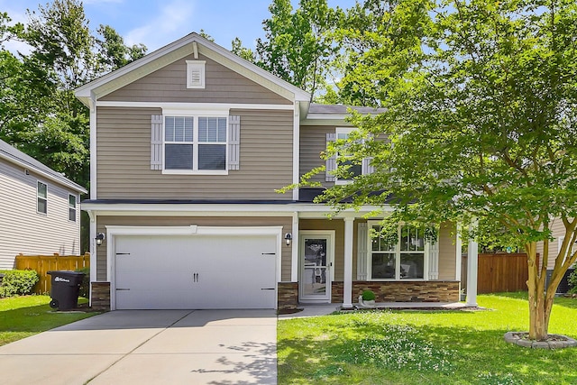 craftsman house featuring a garage and a front lawn