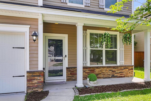 property entrance with a garage and a porch