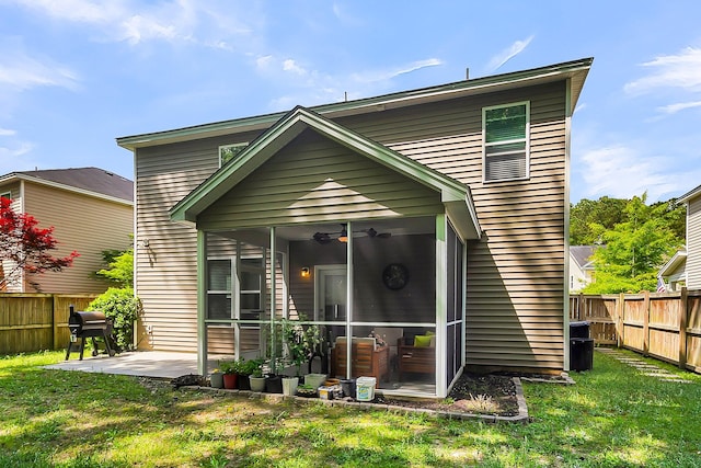 back of property featuring ceiling fan, a patio area, and a lawn