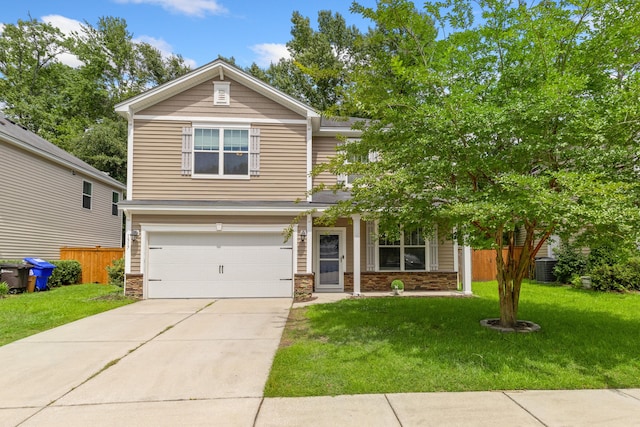 view of front of house with a garage and a front lawn