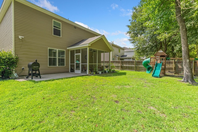 view of yard featuring a playground and a patio