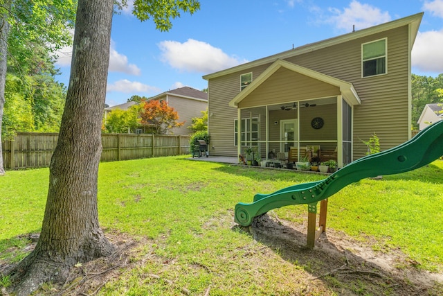 exterior space with ceiling fan, a patio area, and a yard