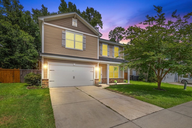 view of front of house with a garage and a yard