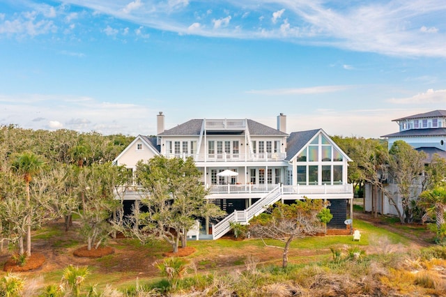 rear view of house featuring a deck and a sunroom