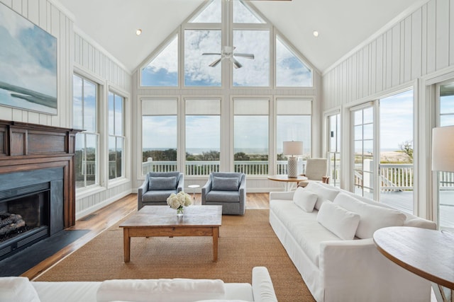 sunroom with vaulted ceiling, ceiling fan, and plenty of natural light