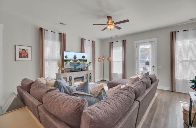 living room featuring light wood-type flooring and ceiling fan