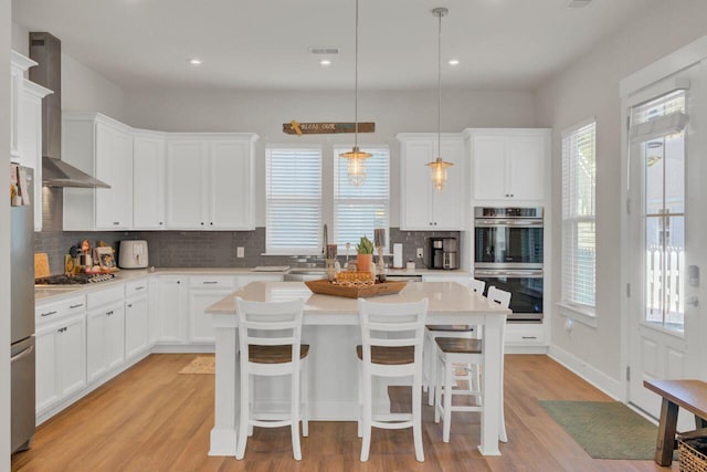 kitchen with a center island and a healthy amount of sunlight