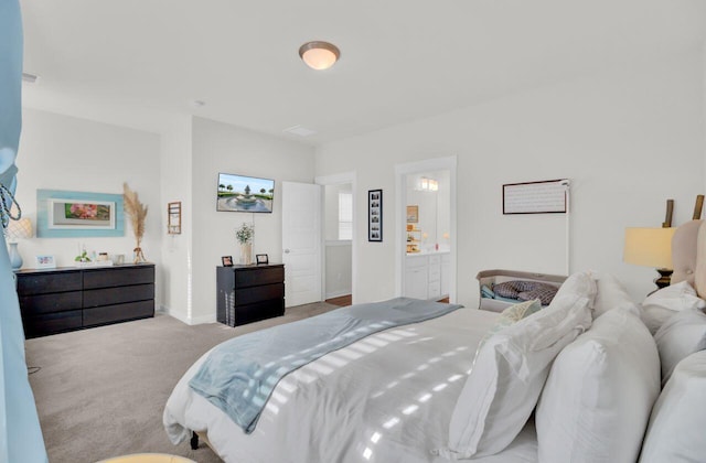 bedroom featuring light colored carpet and connected bathroom