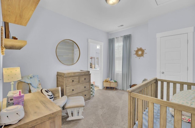 carpeted bedroom featuring a crib