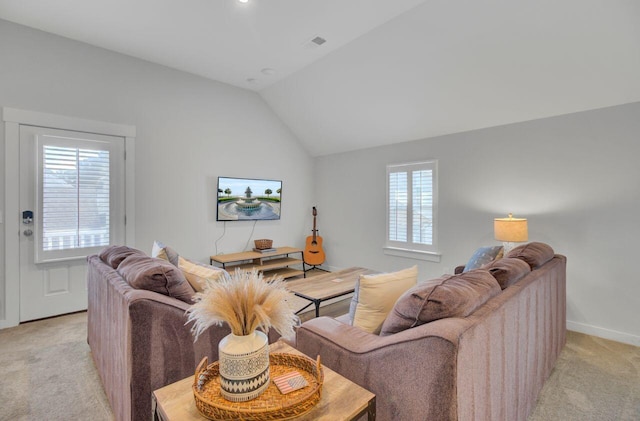 carpeted living room featuring vaulted ceiling