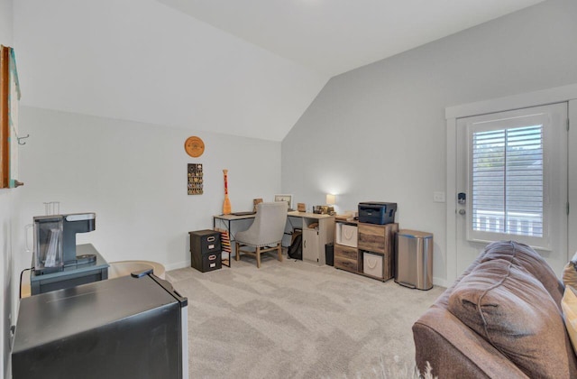 office with light colored carpet and vaulted ceiling