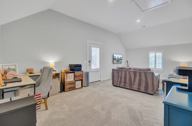 home office featuring light carpet and vaulted ceiling