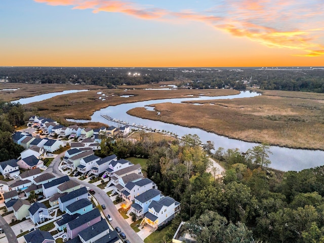 aerial view at dusk with a water view