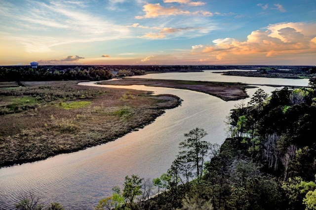 aerial view at dusk with a water view