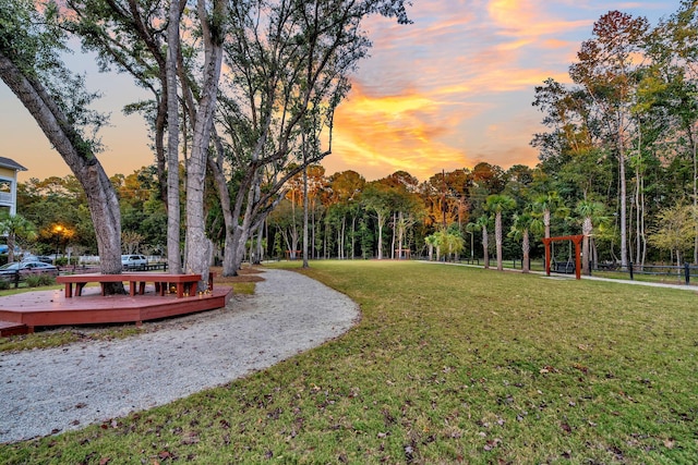 surrounding community with a lawn and a deck