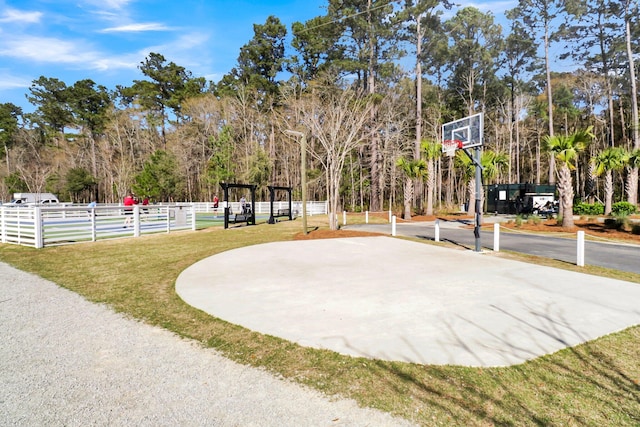 view of basketball court with a yard