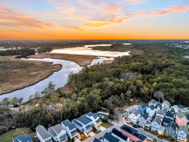 aerial view at dusk with a water view