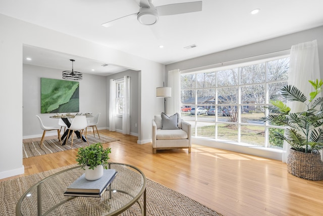 living room with visible vents, baseboards, ceiling fan, recessed lighting, and light wood-style floors