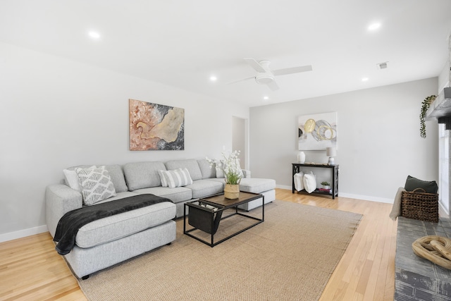 living area with light wood-type flooring, visible vents, baseboards, and recessed lighting