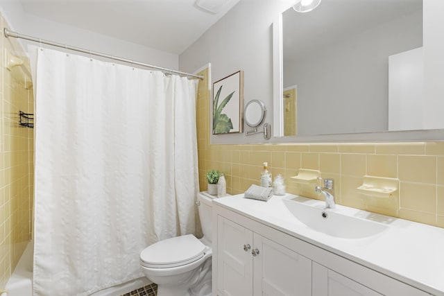 full bath with visible vents, vanity, toilet, and tile walls