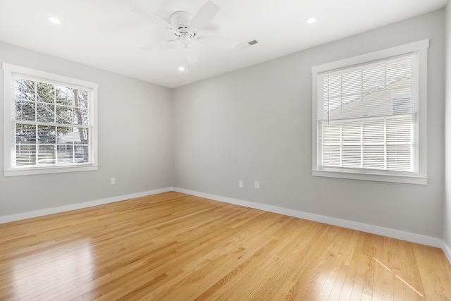 empty room with a ceiling fan, visible vents, baseboards, recessed lighting, and wood-type flooring