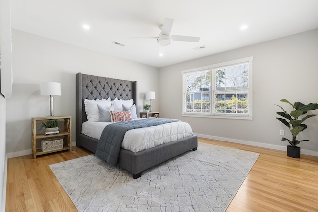 bedroom featuring wood finished floors, visible vents, and baseboards