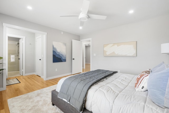 bedroom featuring ensuite bath, recessed lighting, light wood-style floors, baseboards, and ceiling fan