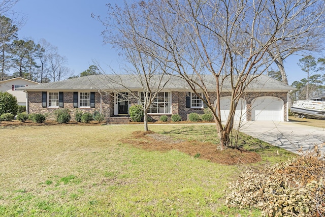 ranch-style home featuring a front yard, an attached garage, brick siding, and driveway