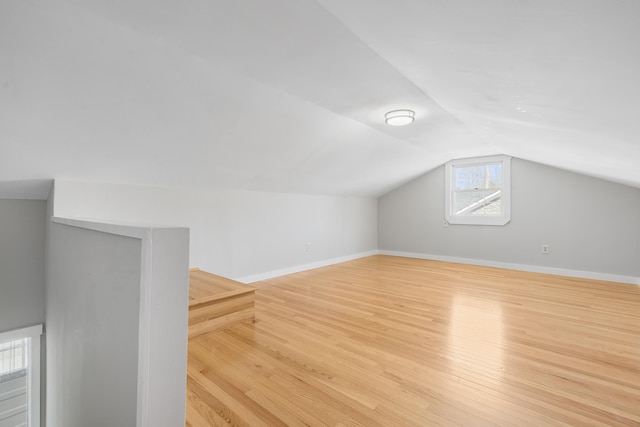 bonus room featuring vaulted ceiling, wood finished floors, and baseboards