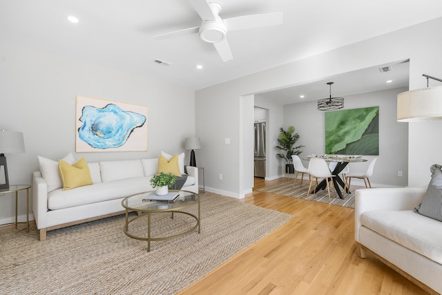 living room with recessed lighting, baseboards, light wood-style floors, and a ceiling fan