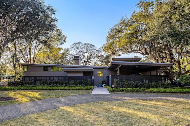 317 Seewee Cir, Mount Pleasant, SC 29464 - mid-century modern home with a chimney, fence private yard, and a front yard
