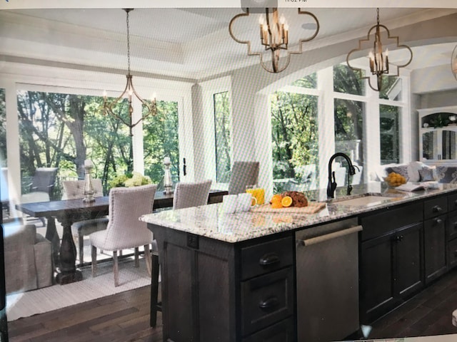 kitchen featuring a notable chandelier, dark hardwood / wood-style flooring, light stone counters, pendant lighting, and stainless steel dishwasher