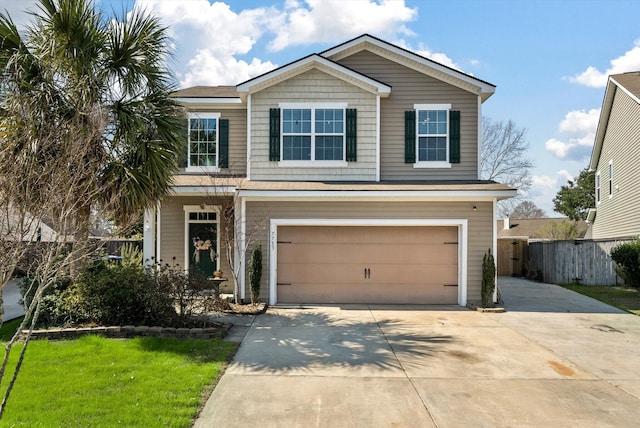 traditional-style home featuring a garage, fence, and concrete driveway