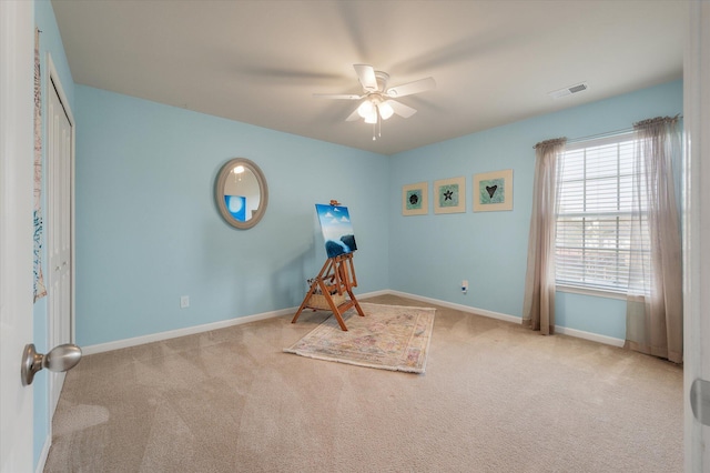 recreation room with ceiling fan, carpet flooring, visible vents, and baseboards