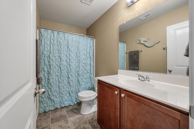 bathroom featuring toilet, visible vents, a shower with shower curtain, and vanity