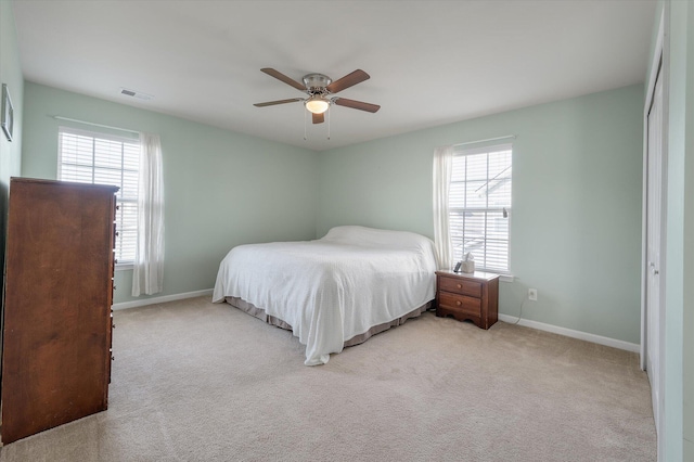 bedroom with multiple windows, carpet, visible vents, and baseboards