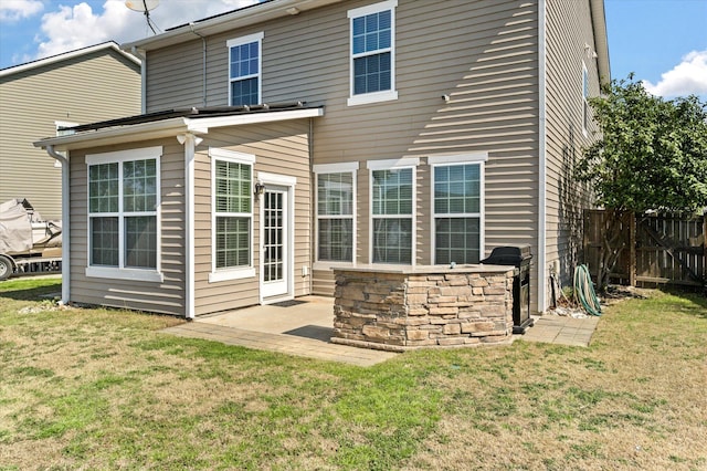 back of house with a yard, fence, and a patio